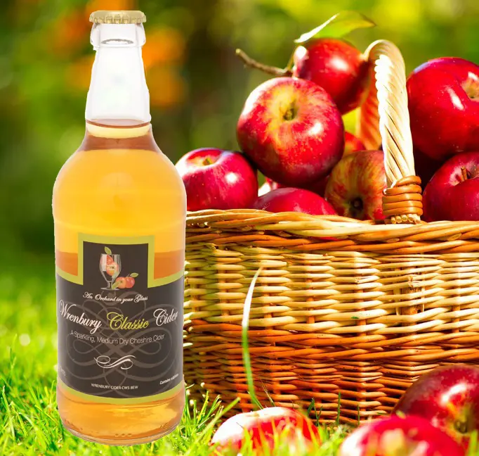 Wrenbury Cider bottle beside a basket of red apples